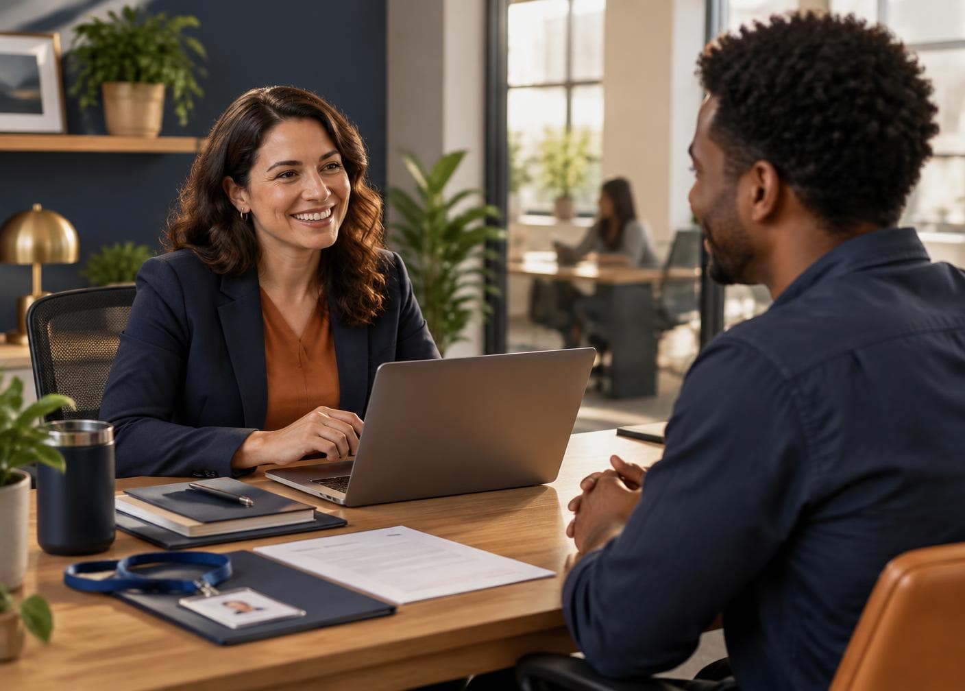 An HR manager and a new hire talking across a desk